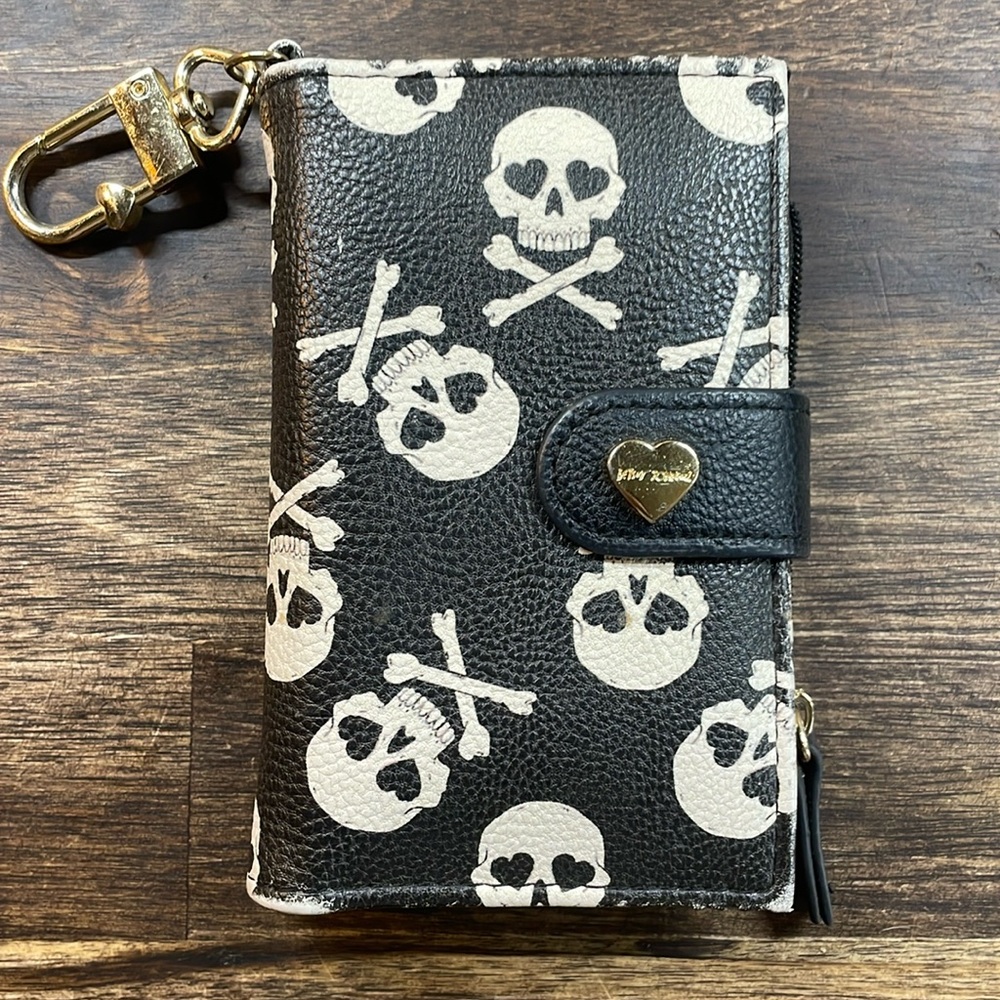 Women’s Betsy Johnson Black wallet with white skulls. Wear on hardware/ edges.